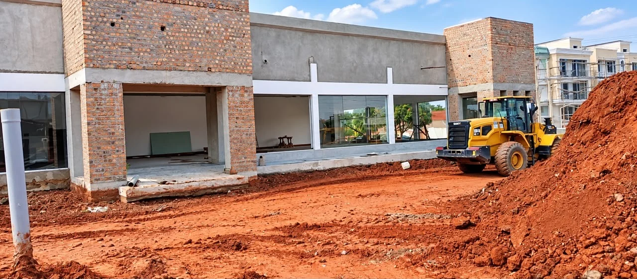 Earthmoving equipment and ground preparation at the commercial frontage.